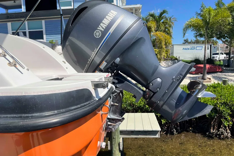 Slide: The Image of 2018 Starcraft SVX 190 OB boat with Yamaha outboard motor, docked near palm trees. - 11