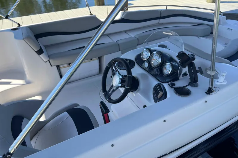 Slide: The Image of 2018 Starcraft SVX 190 OB boat interior with steering wheel and dashboard gauges. - 18