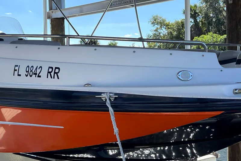 Slide: The Image of 2018 Starcraft SVX 190 OB boat docked, displaying registration FL 9842 RR. - 2