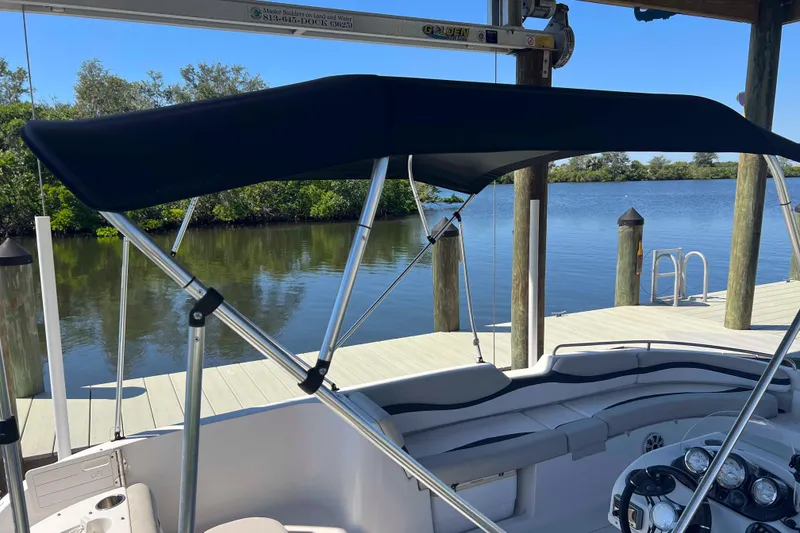 Slide: The Image of 2018 Starcraft SVX 190 OB boat with canopy, docked by a serene lake. - 20