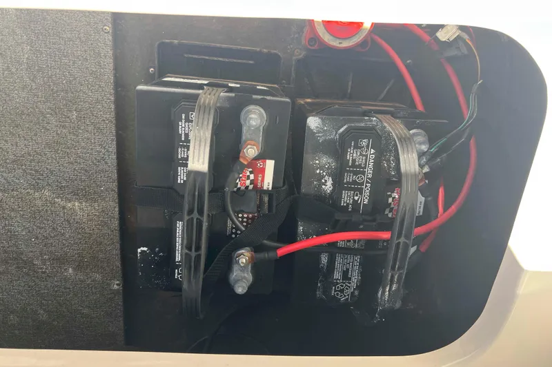 Slide: The Image of 2018 Starcraft SVX 190 OB boat battery compartment with dual batteries and wiring. - 24