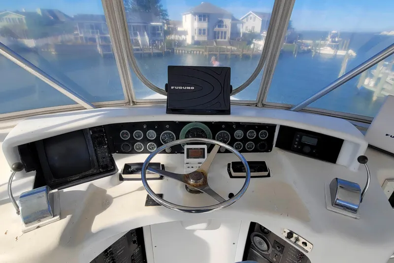 Slide: The Image of Helm of 1984 Tiffany 50 Convertible yacht with steering wheel and navigation instruments. - 10