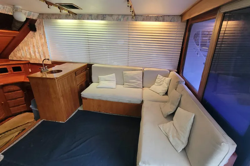 Slide: The Image of Interior of 1984 Tiffany 50 Convertible yacht with cozy seating and wooden cabinetry. - 11