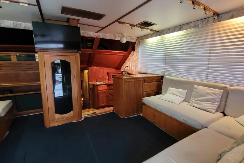 Slide: The Image of Interior of 1984 Tiffany 50 Convertible yacht with cozy seating and wooden cabinetry. - 12