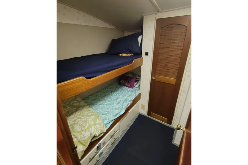 Slide: The Image of Bunk beds in 1984 Tiffany 50 Convertible yacht cabin with wooden door. - 16