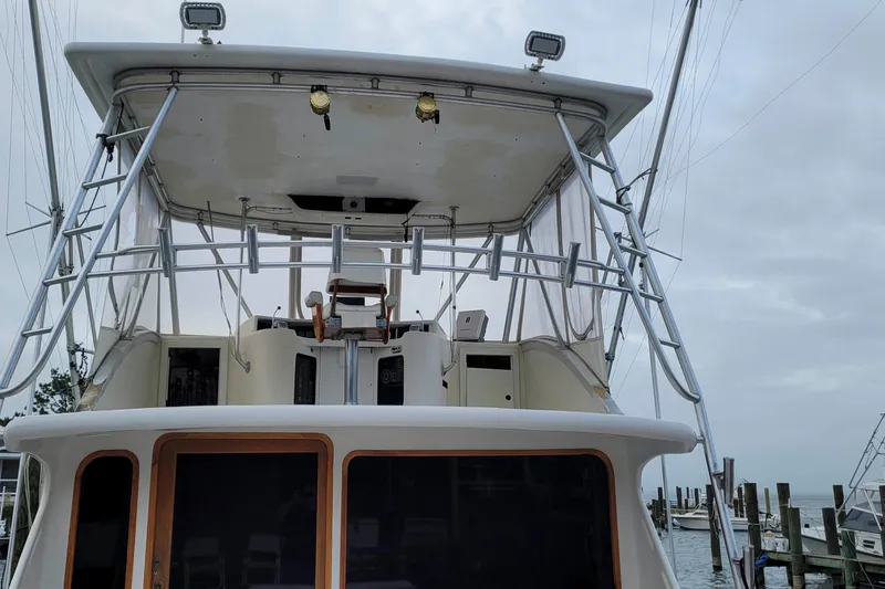 Slide: The Image of 1984 Tiffany 50 Convertible yacht with upper deck and fishing tower, docked at marina. - 9