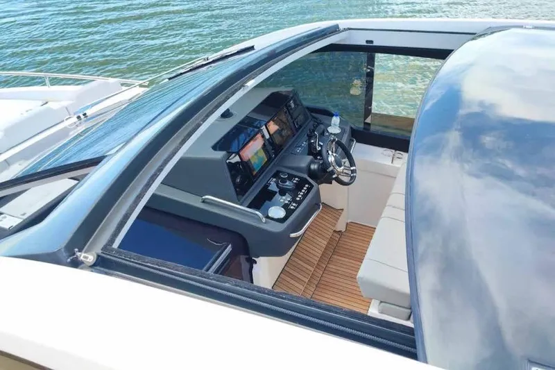 Slide: The Image of 2026 Schaefer 375 yacht cockpit with modern controls and sleek design on the water. - 11
