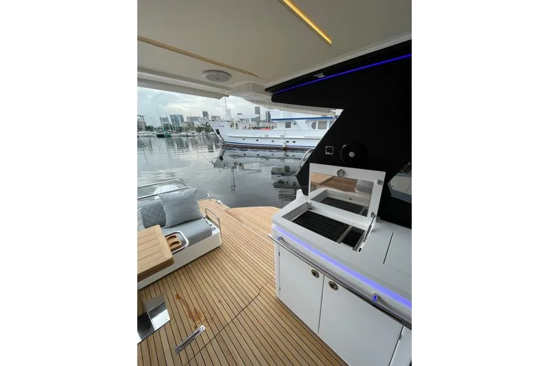 Slide: The Image of Luxurious 2026 Schaefer 375 yacht deck with modern grill and seating area. - 14