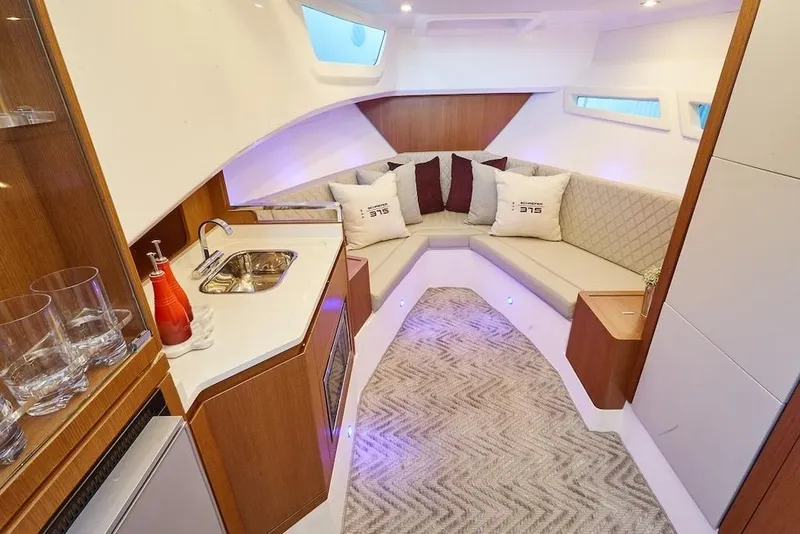 Slide: The Image of Luxurious interior of 2026 Schaefer 375 yacht with modern seating and kitchenette. - 18