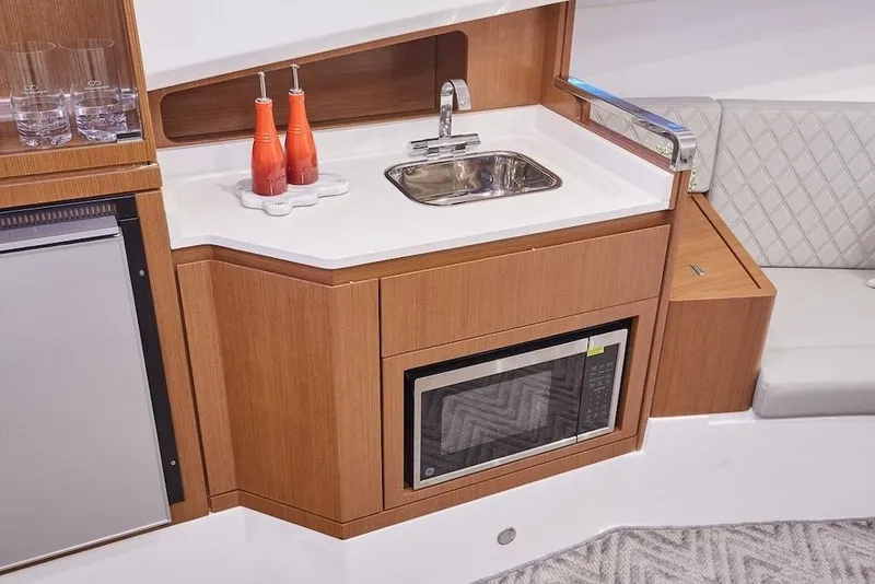 Slide: The Image of Compact kitchen area in 2026 Schaefer 375 yacht with sink, microwave, and mini fridge. - 21
