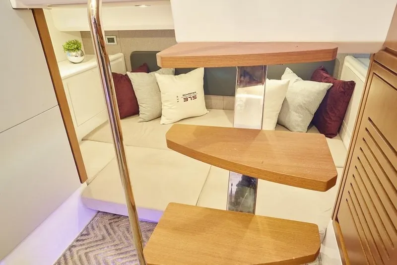 Slide: The Image of Modern Schaefer 375 yacht interior with wooden steps and cozy seating area, 2026 model. - 25