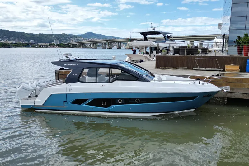 Slide: The Image of Schaefer 375 boat docked by the water, 2026 model, with scenic background. - 27