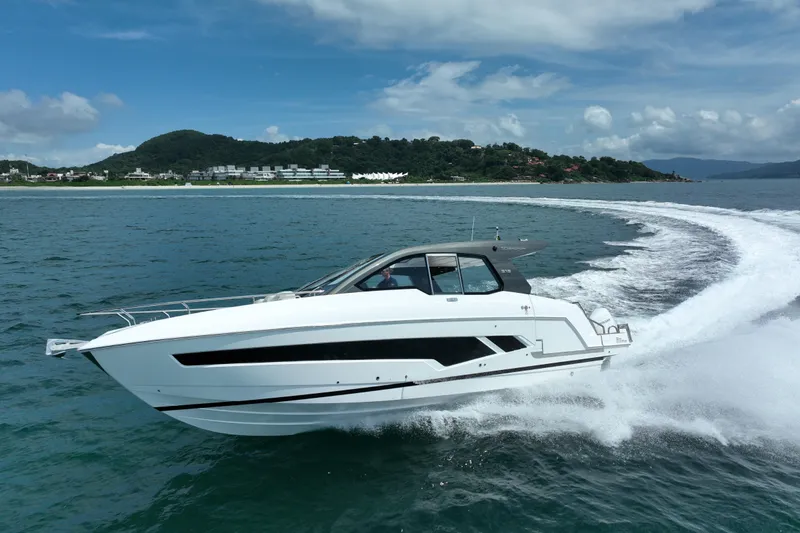 Slide: The Image of 2026 Schaefer 375 yacht cruising on open water with scenic coastline backdrop. - 3