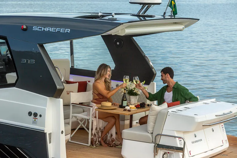 Slide: The Image of Couple enjoying a toast on a 2026 Schaefer 375 yacht by the water. - 30