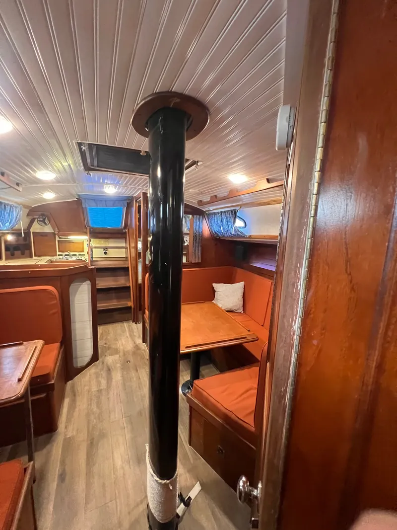 Slide: The Image of Interior of 1981 Ericson 38 sailboat with wood paneling and cozy seating area. - 13
