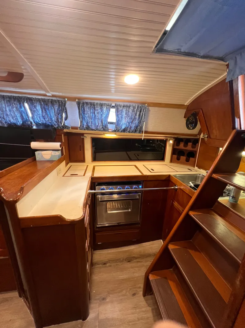 Slide: The Image of Interior of 1981 Ericson 38 sailboat galley with wood finish and modern appliances. - 15