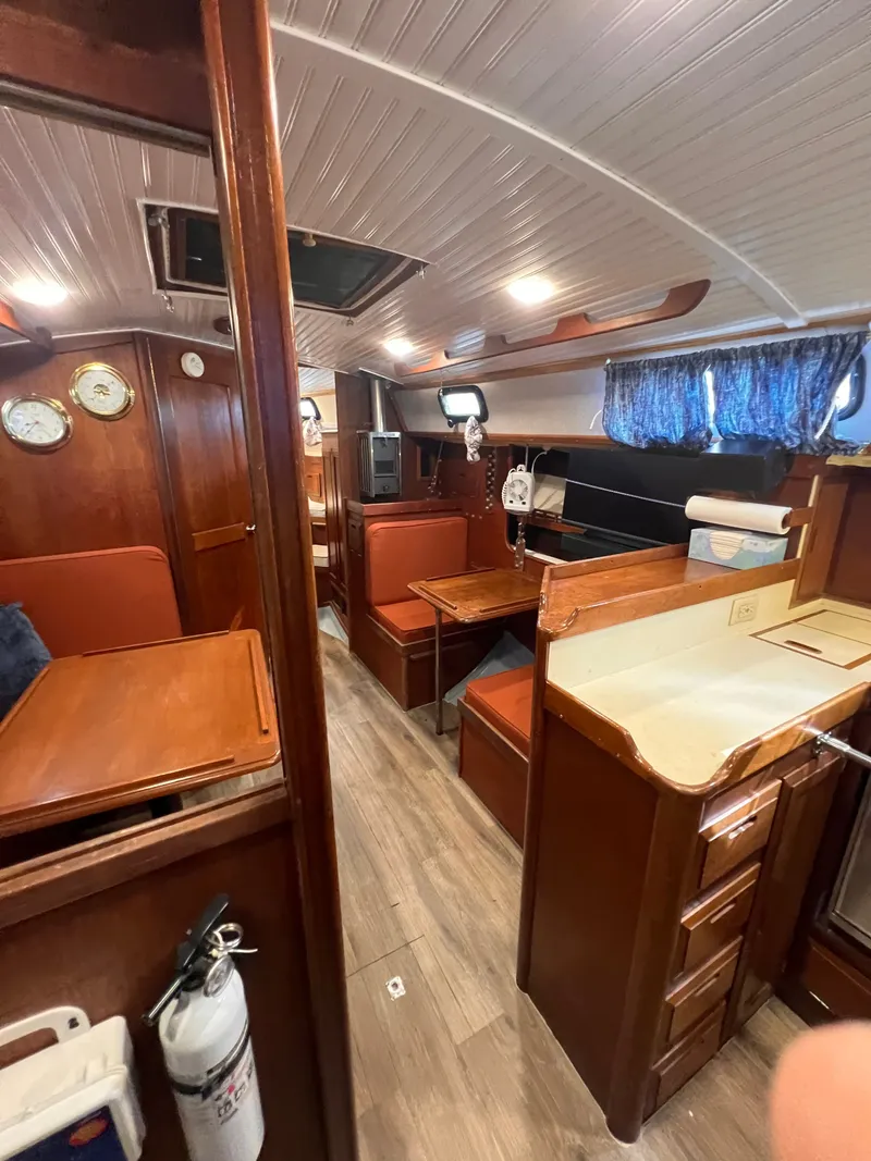 Slide: The Image of Interior of 1981 Ericson 38 sailboat with wood finish and cozy seating area. - 16