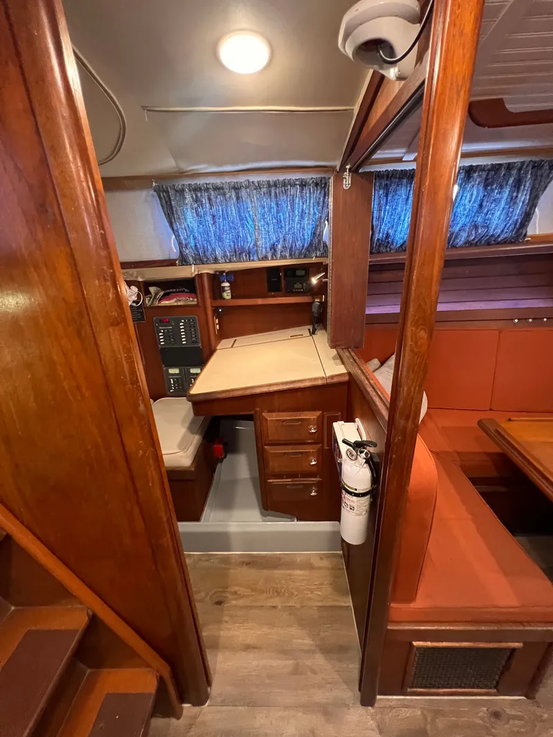 Slide: The Image of Interior of 1981 Ericson 38 sailboat with wood finish and seating area. - 18