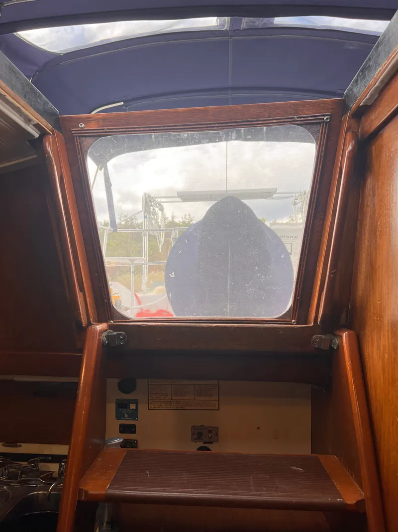 Slide: The Image of Interior view of 1981 Ericson 38 sailboat cabin with wooden finish and hatch. - 19