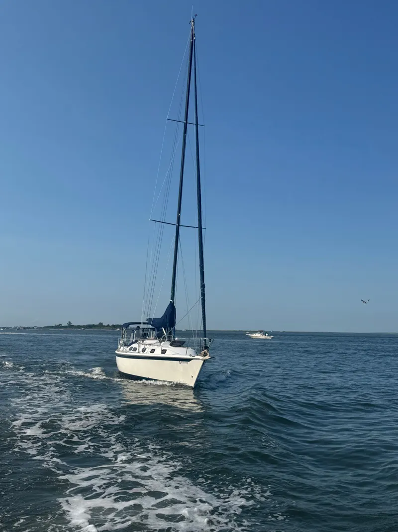 Slide: The Image of Sailboat on open water, Ericson 38, 1981 model, under clear blue sky. - 2