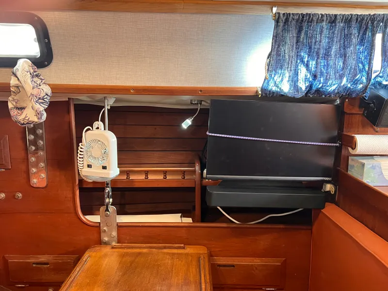 Slide: The Image of Interior of 1981 Ericson 38 sailboat with fan, TV, and wooden furnishings. - 20