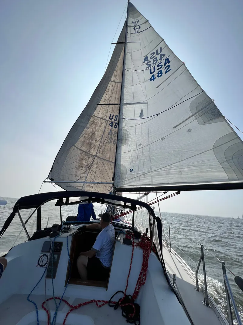 Slide: The Image of Sailing on a 1981 Ericson 38 yacht with full sails on open water. - 5