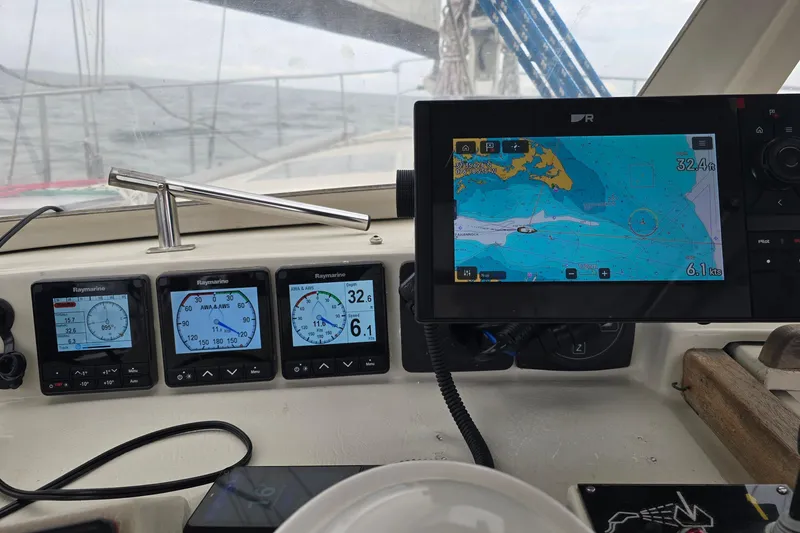 Slide: The Image of Cockpit of 1993 Amel Santorin sailboat with navigation instruments and digital map display. - 14