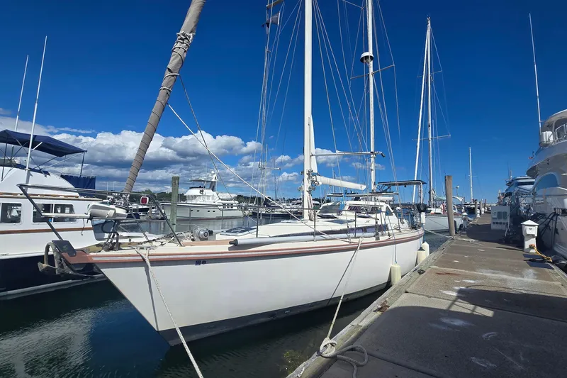 Slide: The Image of Sailboat Amel Santorin 1993 docked at marina under clear blue sky. - 2