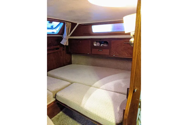 Slide: The Image of Cozy cabin interior of 1993 Amel Santorin sailboat with cushioned seating and wooden accents. - 20