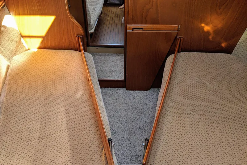 Slide: The Image of Interior of 1993 Amel Santorin yacht with twin beds and wooden paneling. - 22