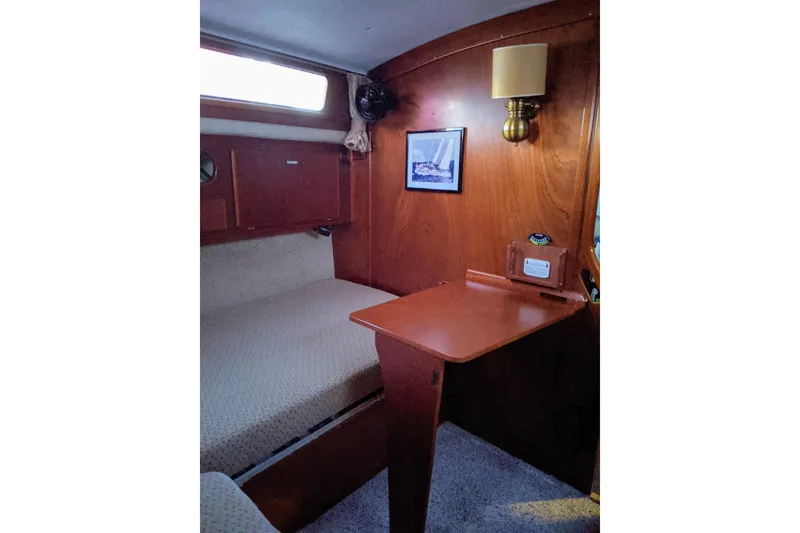 Slide: The Image of Cozy cabin interior of 1993 Amel Santorin sailboat with wooden desk and bed. - 24