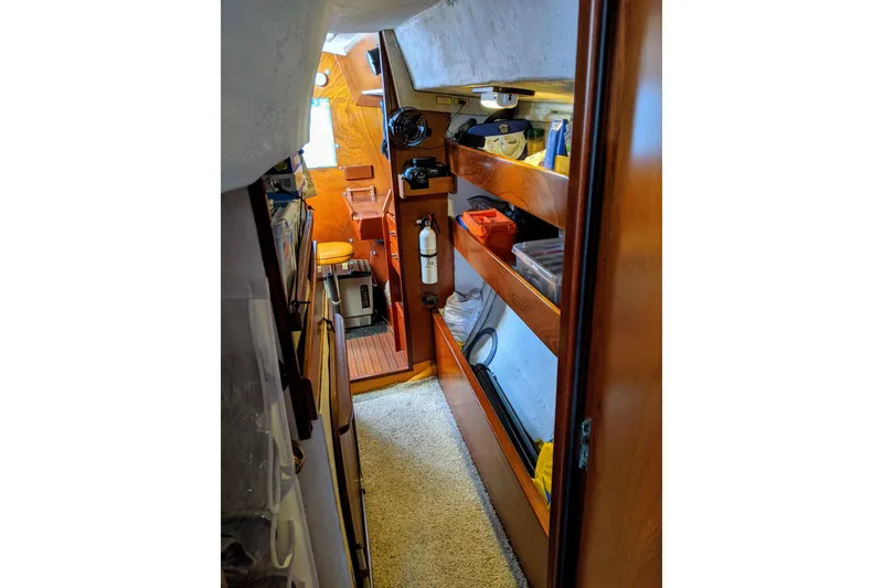 Slide: The Image of Interior of 1993 Amel Santorin sailboat with wooden shelves and nautical equipment. - 29