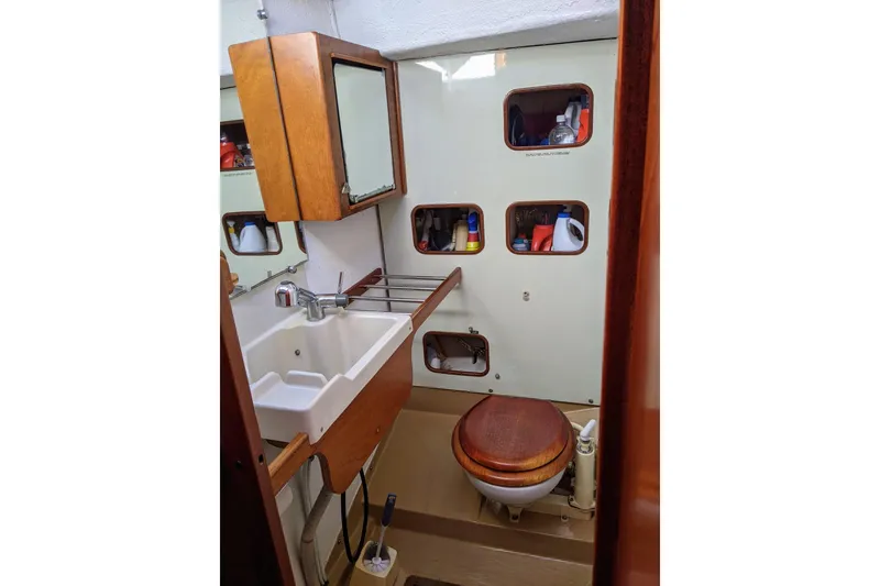Slide: The Image of Bathroom interior of 1993 Amel Santorin yacht with sink and wooden toilet seat. - 31