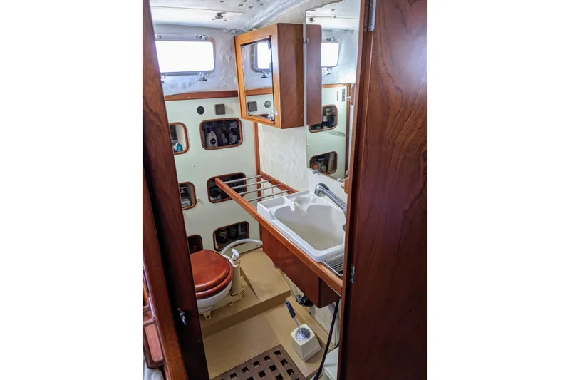 Slide: The Image of Interior of 1993 Amel Santorin yacht bathroom with wooden cabinetry and sink. - 32