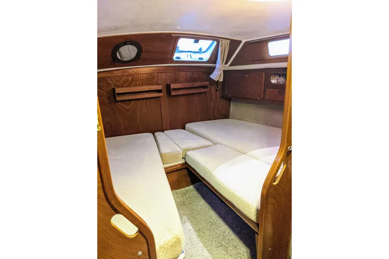 Slide: The Image of 1993 Amel Santorin yacht interior cabin with wooden finish and cozy seating. - 34