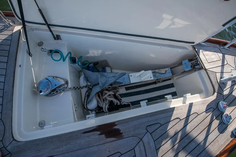 Slide: The Image of Open storage compartment on 2007 Morris Yachts M42, featuring anchor and coiled hose. - 12