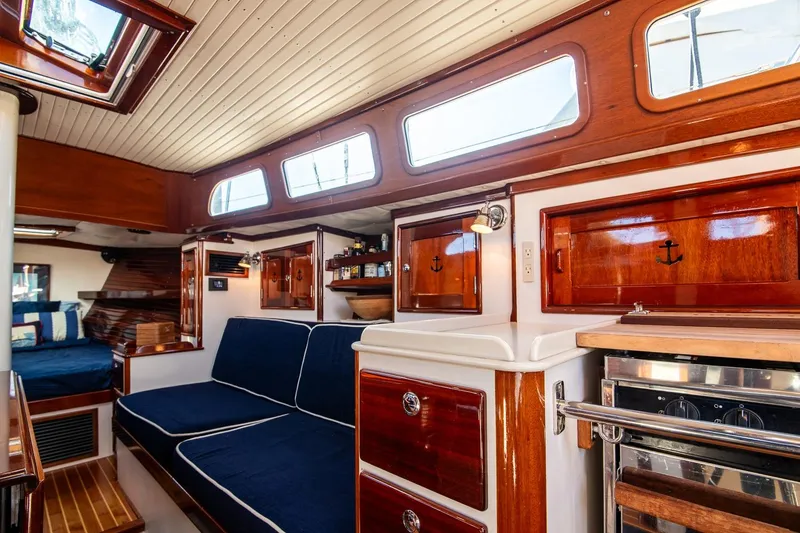 Slide: The Image of Luxurious 2007 Morris Yachts M42 interior with polished wood and navy seating. - 19