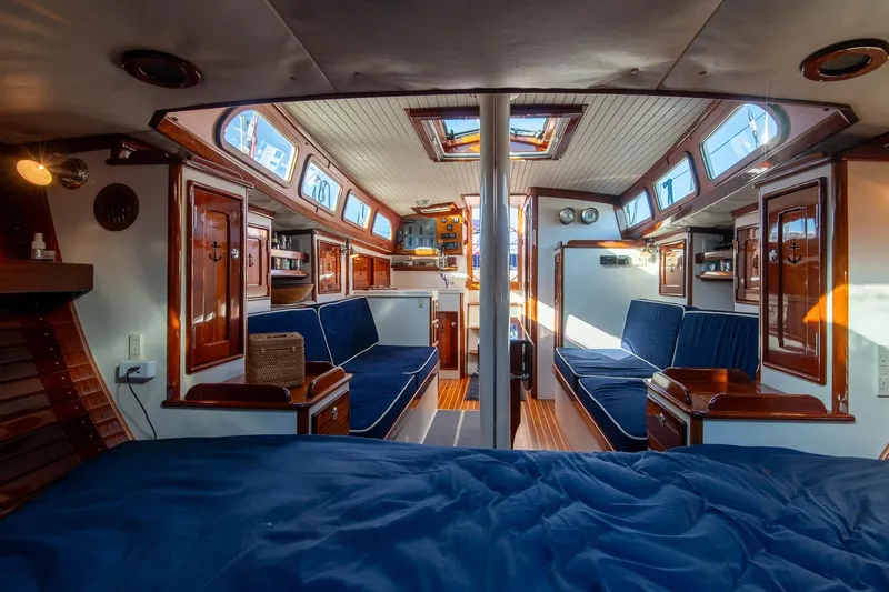 Slide: The Image of Luxurious 2007 Morris Yachts M42 interior with elegant wood finishes and blue upholstery. - 25