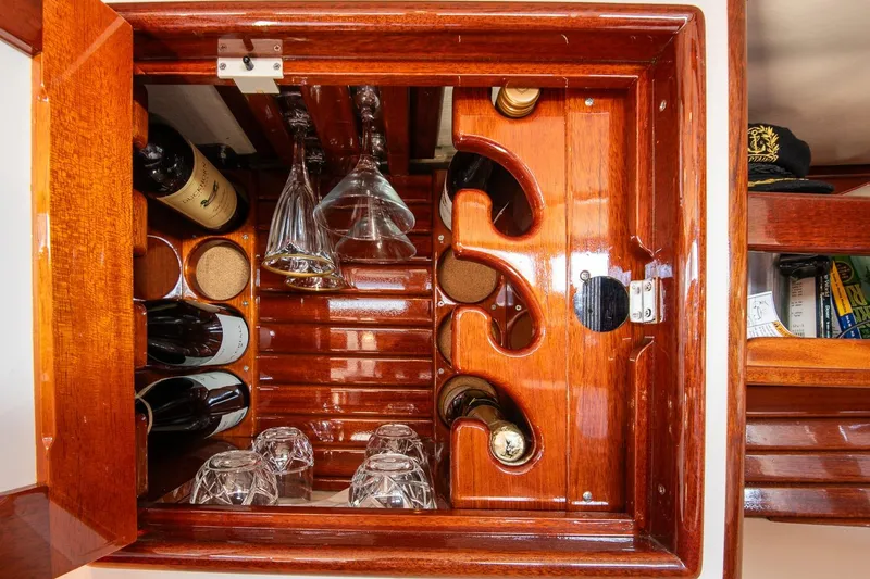 Slide: The Image of Luxurious wooden wine cabinet on 2007 Morris Yachts M42, featuring bottles and glasses. - 27