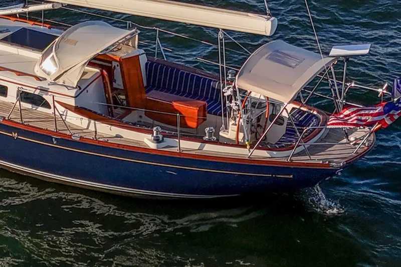 Slide: The Image of 2007 Morris Yachts M42 sailboat with American flag on water. - 4