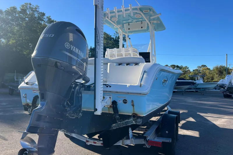 Slide: The Image of 2019 Sea Hunt Ultra 225 boat with Yamaha engine on trailer, parked outdoors. - 3