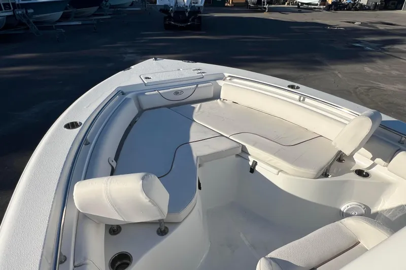 Slide: The Image of 2019 Sea Hunt Ultra 225 boat interior with white seating and cup holders. - 5