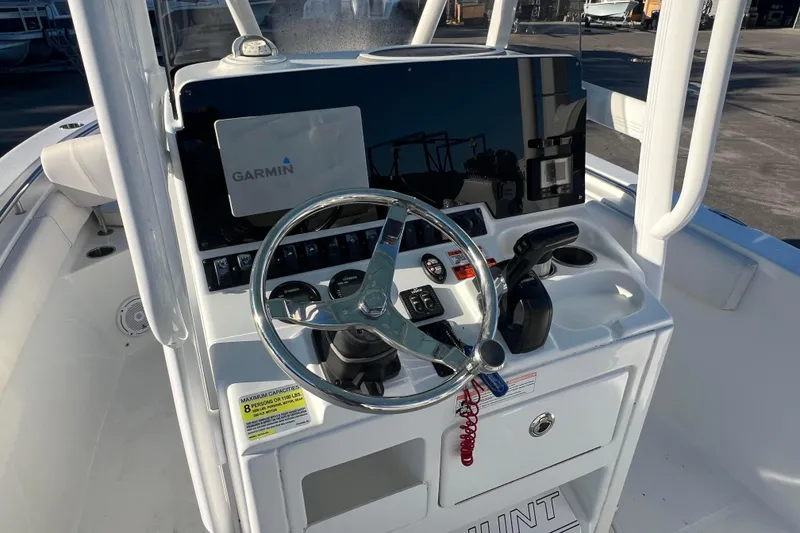 Slide: The Image of 2019 Sea Hunt Ultra 225 boat console with Garmin navigation system and steering wheel. - 6