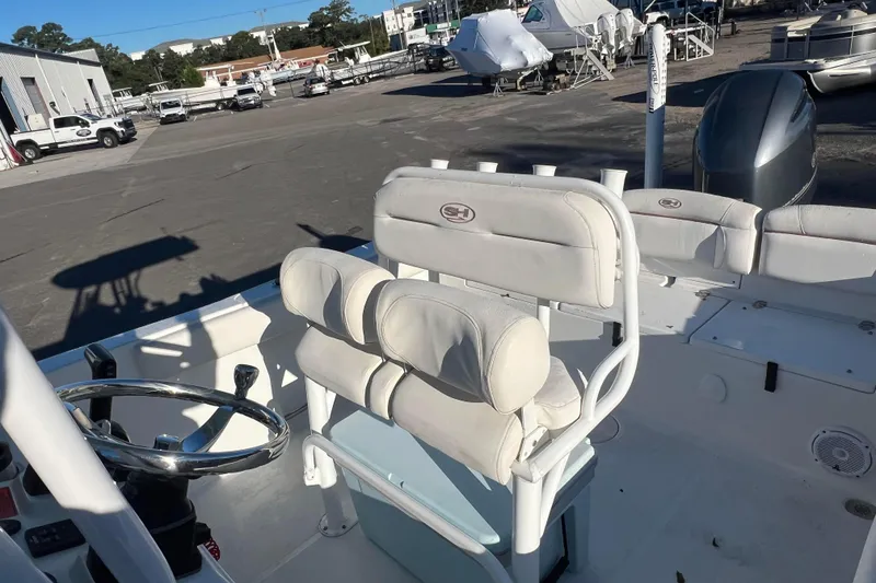 Slide: The Image of 2019 Sea Hunt Ultra 225 boat interior with white seating and steering wheel. - 8