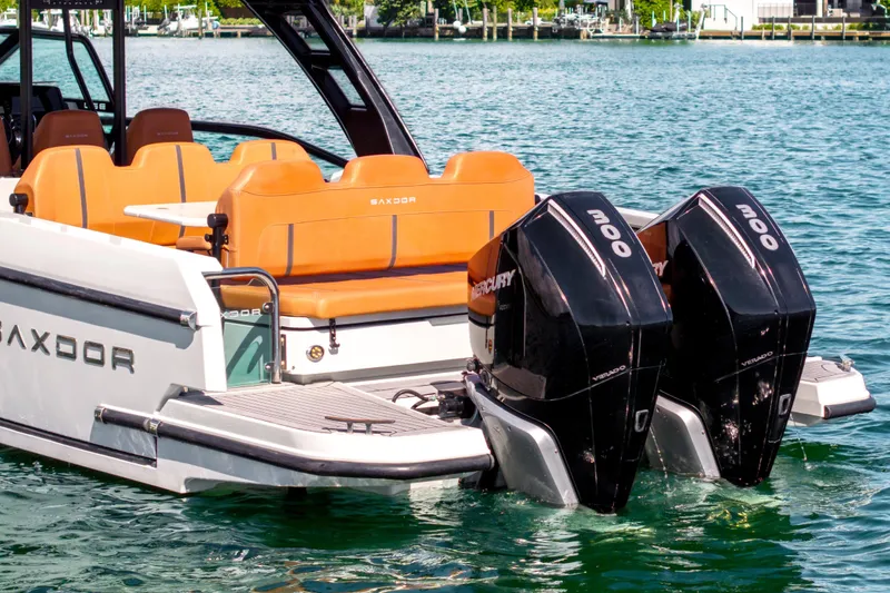 Slide: The Image of 2021 Saxdor 320 GTO boat with dual Mercury engines on a sunny day. - 15