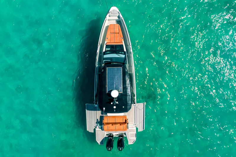 Slide: The Image of Aerial view of 2021 Saxdor 320 GTO boat on turquoise water. - 16