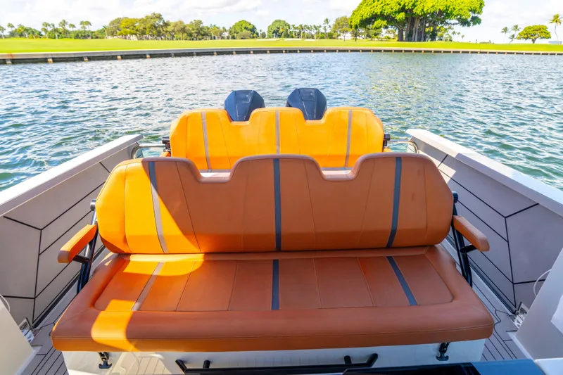 Slide: The Image of 2021 Saxdor 320 GTO boat with orange seating, on a sunny day by the water. - 21