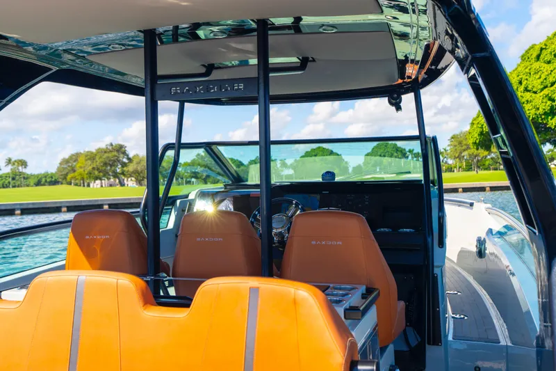 Slide: The Image of 2021 Saxdor 320 GTO boat interior with orange seats and sleek dashboard design. - 23