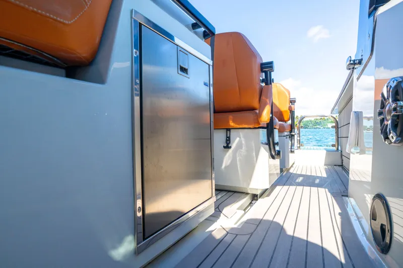 Slide: The Image of 2021 Saxdor 320 GTO boat interior with orange seats and stainless steel features. - 27