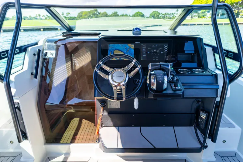 Slide: The Image of Cockpit of 2021 Saxdor 320 GTO with steering wheel and navigation controls. - 28